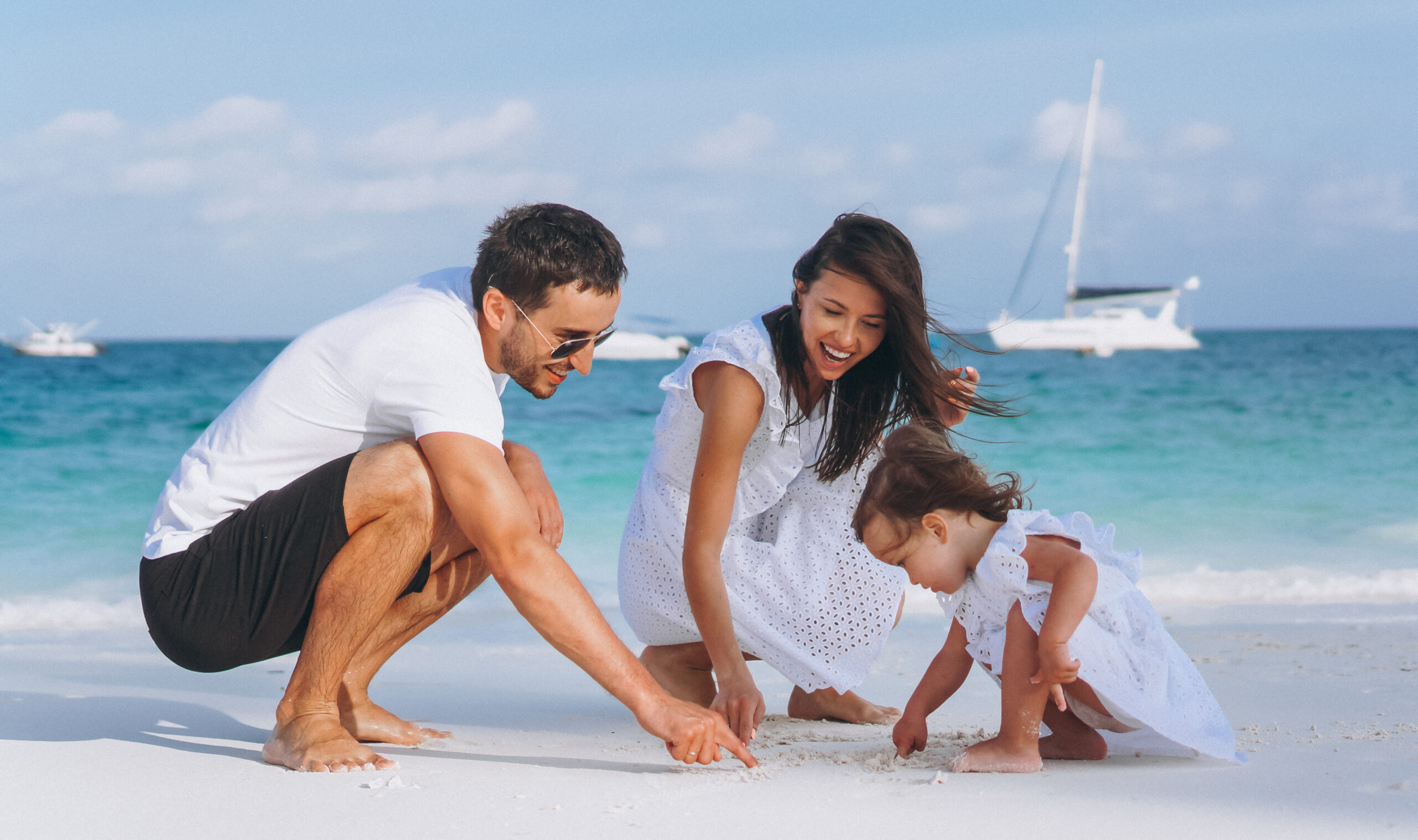 Young family with little daughter on a vacation by the ocean - Buying luxury real estate Bahamas